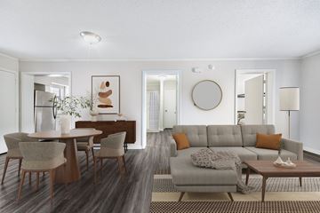 Prairie Village apartment for rent - A modern living room with a grey sofa and wooden chairs.