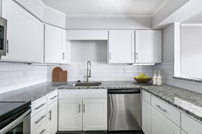 Prairie Village apartment for rent - A kitchen with white cabinets and a granite countertop.