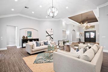 Plano apartment for rent - A living room with a white couch and a rug.