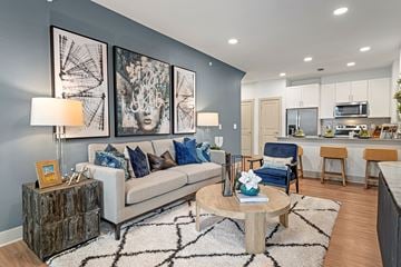 Kennedale apartment for rent - A modern living room with a white couch and a coffee table.