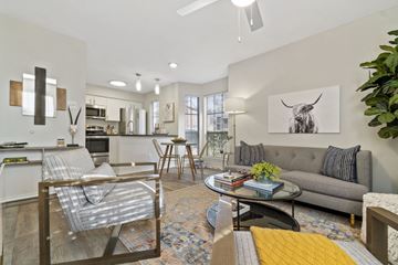 Fort Worth apartment for rent - A living room with a grey couch and a coffee table.