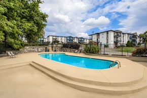 Nashville apartment for rent - A swimming pool surrounded by a concrete deck and a fence.