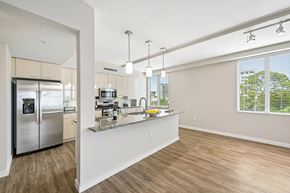 Sarasota apartment for rent - A kitchen with a refrigerator, sink, and countertop.