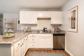 Lexington apartment for rent - A kitchen with white cabinets and a granite countertop.
