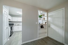 Smyrna apartment for rent - A kitchen with white cabinets and a white door.