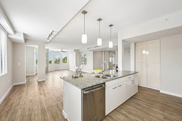 Sarasota apartment for rent - A modern kitchen with a large island and wooden floors.