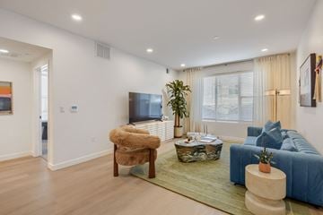 West Jordan apartment for rent - A living room with a blue couch and a brown chair.