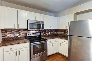 Lebanon apartment for rent - a kitchen with stainless steel appliances and white cabinets