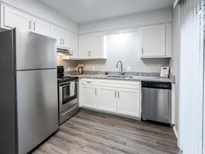 Fayetteville apartment for rent - a kitchen with stainless steel appliances and white cabinets