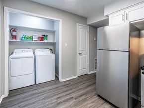 Fayetteville apartment for rent - a washer and dryer in a laundry room with a stainless steel refrigerator