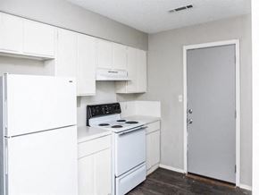 Fayetteville apartment for rent - a kitchen with white cabinets and a white refrigerator