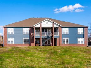 Springdale apartment for rent - a large blue house with a yard in front of it