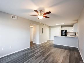 Springdale apartment for rent - an empty living room and kitchen with a ceiling fan
