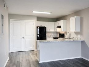 Springdale apartment for rent - an empty kitchen with white cabinets and a counter top