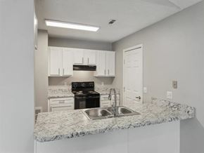 Springdale apartment for rent - a kitchen with granite counter tops and a sink