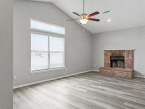 Springdale apartment for rent - an empty living room with a fireplace and a ceiling fan