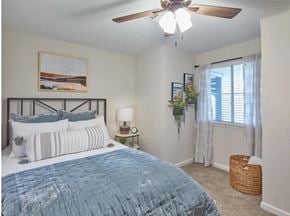 Lexington apartment for rent - a bedroom with two beds and a ceiling fan and a window