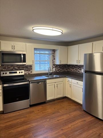Cape Elizabeth apartment for rent - a kitchen with stainless steel appliances and white cabinets
