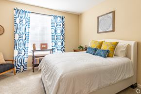Lawrenceville apartment for rent - Overlook at Gwinnett Stadium spacious bedroom featuring queen size bed. Lawrenceville, GA.