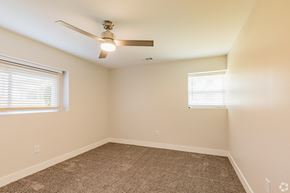 Shawnee Mission apartment for rent - a bedroom with two windows and a ceiling fan