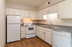 Shawnee Mission apartment for rent - a kitchen with white appliances and white cabinets