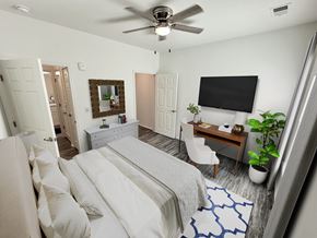 Columbus apartment for rent - A bedroom with a large bed and a flat screen TV mounted on the wall.