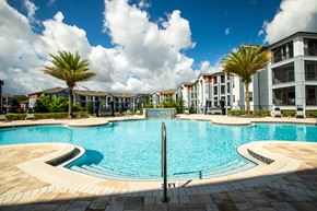 Deland apartment for rent - a large swimming pool with apartments in the background at Century Dunes Apartments, Deland
