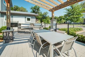 Gainesville apartment for rent - a dining area with a table and chairs under a pergola at Century Town Center, Gainesville, FL
