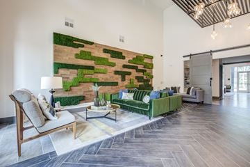 Charlotte apartment for rent - a living room with a green couch and a brick wall
