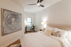 Lee's Summit apartment for rent - a bedroom with a large bed and a ceiling fan  at Century West Pryor, Lee's Summit