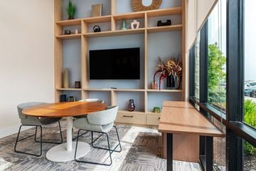 Lee's Summit apartment for rent - a living room with a table and chairs and a television
