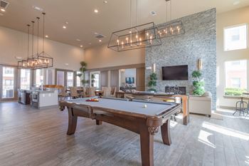 A clubhouse with a pool table and a tv