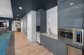 Atlanta apartment for rent - a kitchen with gray cabinets and a brick floor at Marley EAV, Atlanta, GA, 30316