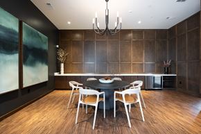Huntsville apartment for rent - A modern dining room with a black table and chairs.