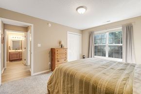 Asheville apartment for rent - A bedroom with a large bed and a dresser.