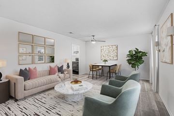 Savannah apartment for rent - A living room with a grey sofa, a coffee table, and a dining table with chairs.
