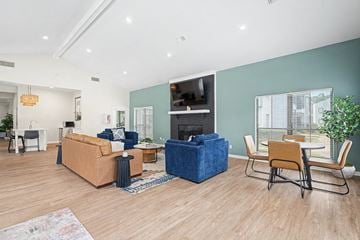 Little Rock apartment for rent - A living room with a blue sofa and a wooden floor.