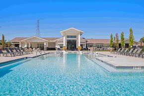 Murfreesboro apartment for rent - Resort-style swimming pool for residents to enjoy surrounded by lounge chairs and pergolas.