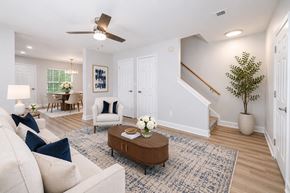 Moncks Corner apartment for rent - A living room with a white couch, a coffee table, and a ceiling fan.