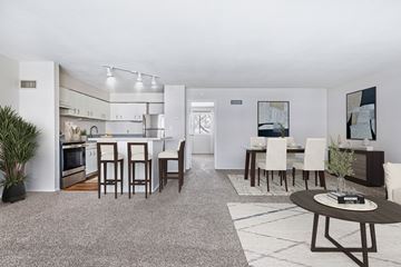 Prairie Village apartment for rent - A modern kitchen with white cabinets and a dining table set with chairs.