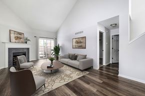 Prairie Village apartment for rent - A living room with a fireplace, two couches, a coffee table, and a rug.