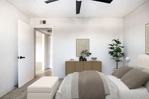 Kansas City apartment for rent - A bedroom with a bed, nightstand, and a plant.