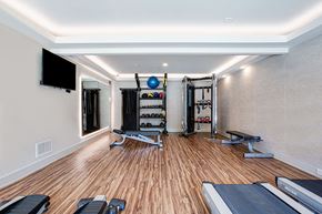Decatur apartment for rent - a gym with weights and a tv on the wall