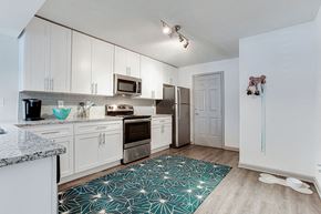 Decatur apartment for rent - a kitchen with white cabinets and a stainless steel refrigerator