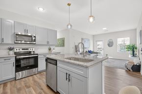 Murfreesboro apartment for rent - Bright apartment kitchen with a center island, pendant lighting, and cozy dining alcove at Farmhouse Apartments in Murfreesboro, TN.