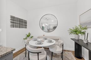 Murfreesboro apartment for rent - Contemporary kitchen featuring pendant lights, generous storage, and a dining alcove at Farmhouse Apartments in Murfreesboro, Tennessee.