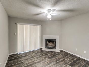 A room with a fireplace and a ceiling fan.