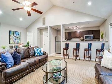 Canton apartment for rent - A living room with a brown leather couch and a glass coffee table.
