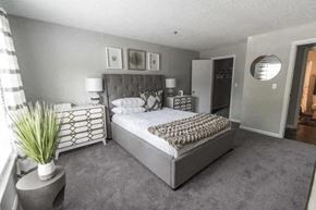 Decatur apartment for rent - a bedroom with a large bed and a mirror at The Sapphire, Georgia