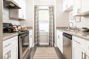Decatur apartment for rent - a kitchen with stainless steel appliances and white cabinets at The Sapphire, Decatur, Georgia